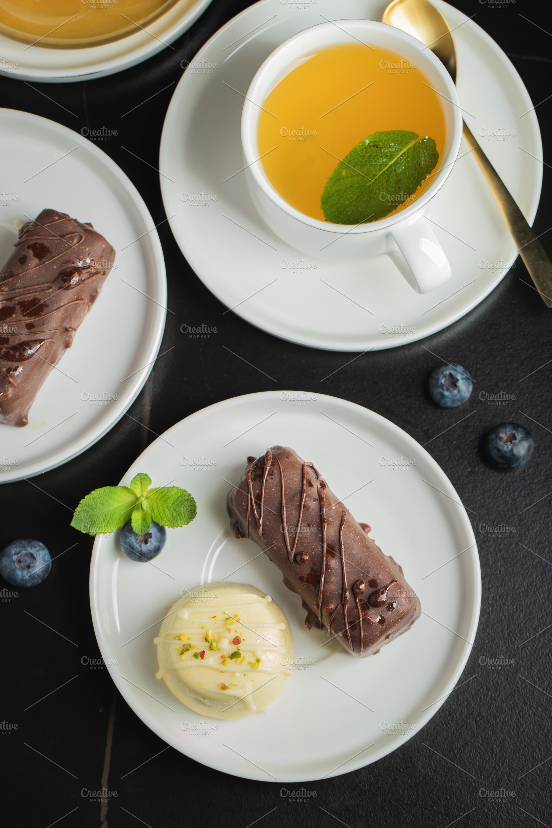 Delicious glazed curd snacks with fresh blueberries and mint on light grey tabl, a Food & Drink Photo by Budarinphoto