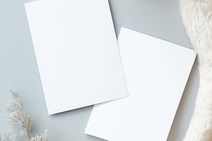Blank vertical cards mockup with winter plant decoration and cozy sweater flat, a Holiday Photo by Studio ANNA