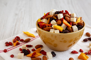 Healthy Dried Fruit and Nut Mix in a Bowl, side view. Close-up., a Food & Drink Photo by LiudmylaChuhunova