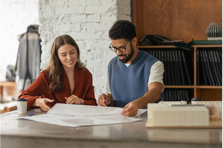 Young couple working as architects, a Business Photo by HalfPoint