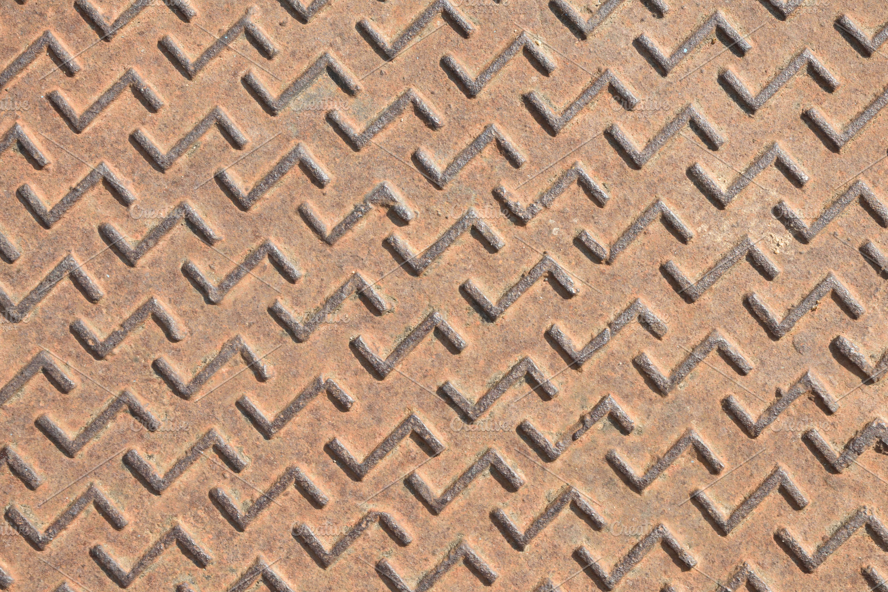 Detail of rusty metal manhole cover with engraved pattern, a Background Photo by Davizro's Market