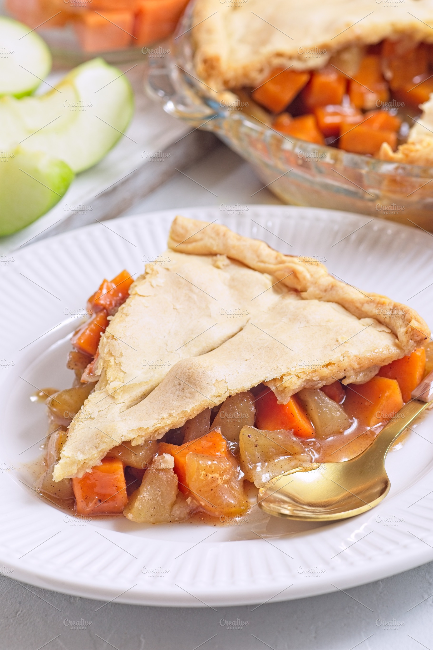Apple and sweet potato cobbler pie showing filling ingredients, on white plate, a Food & Drink Photo by iuliia_n