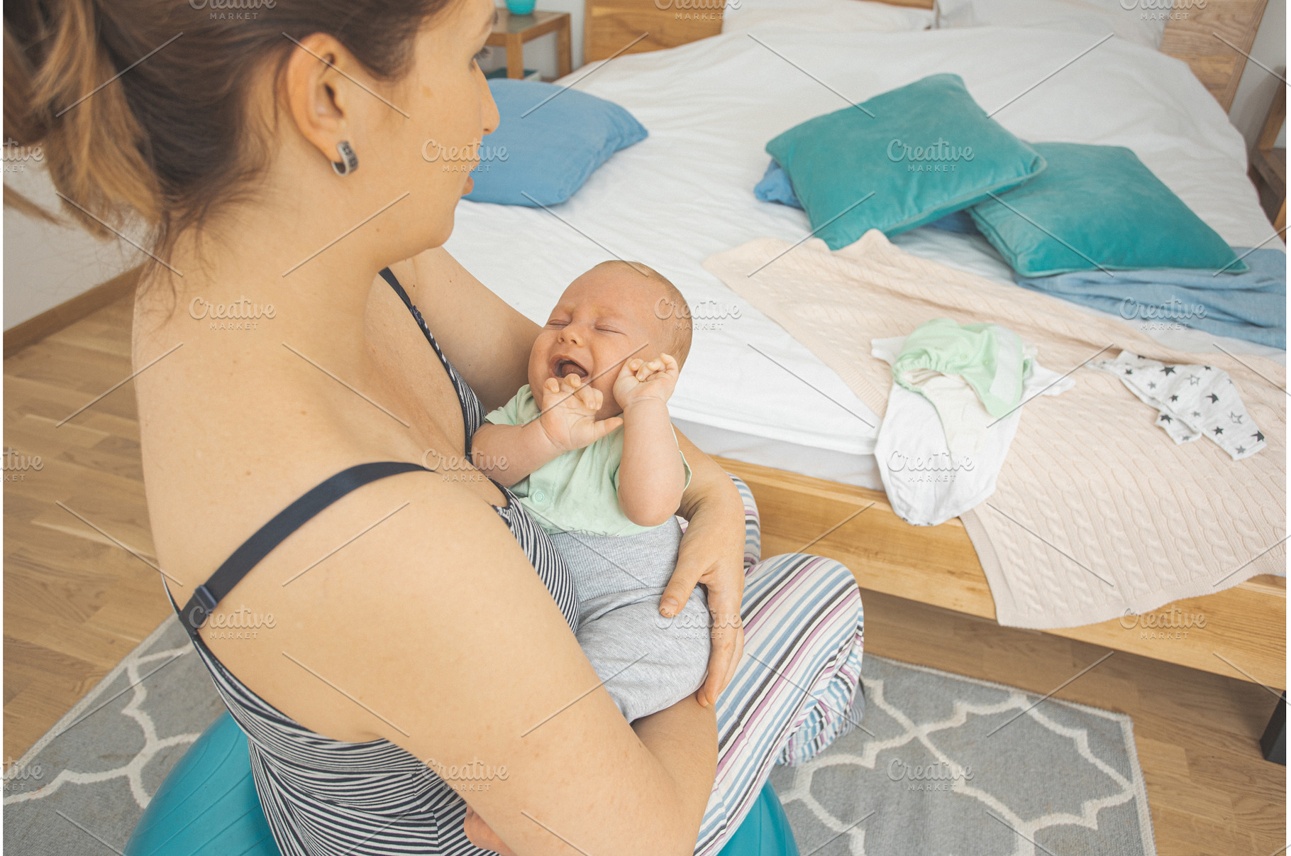 Mother holding and rocking baby, a Person Photo by oksix