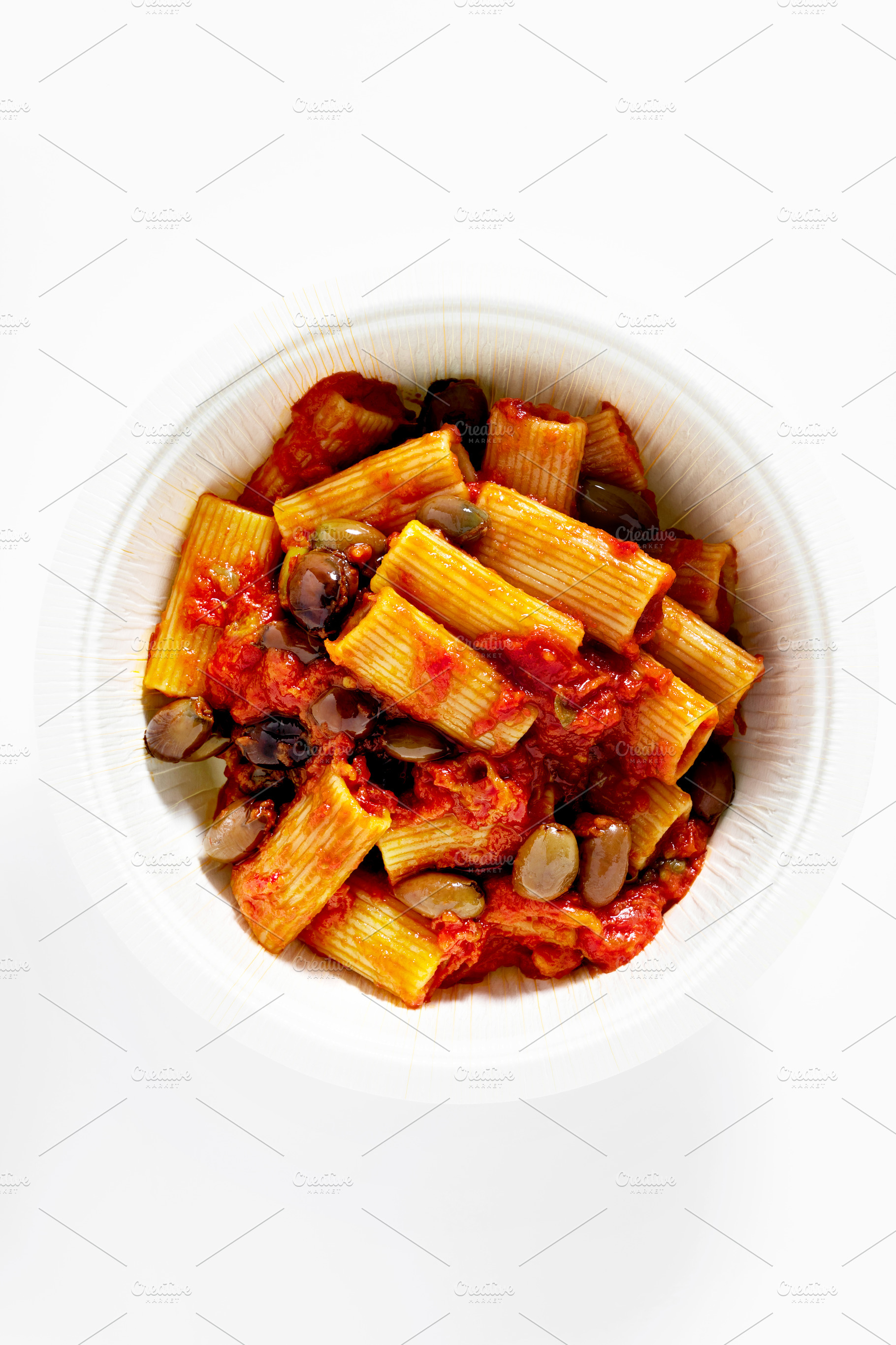 Italian tortiglioni pasta puttanesca with tomato sauce and black, a Food & Drink Photo by IriGri