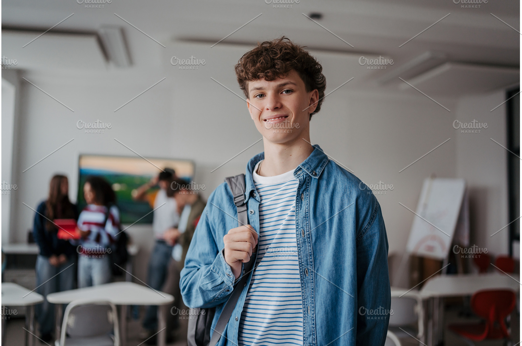 Confident teen student in classroom, a School & Education Photo by HalfPoint