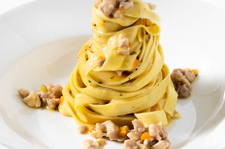 pasta tagliatelle with rabbit sauce on the white table. menu for