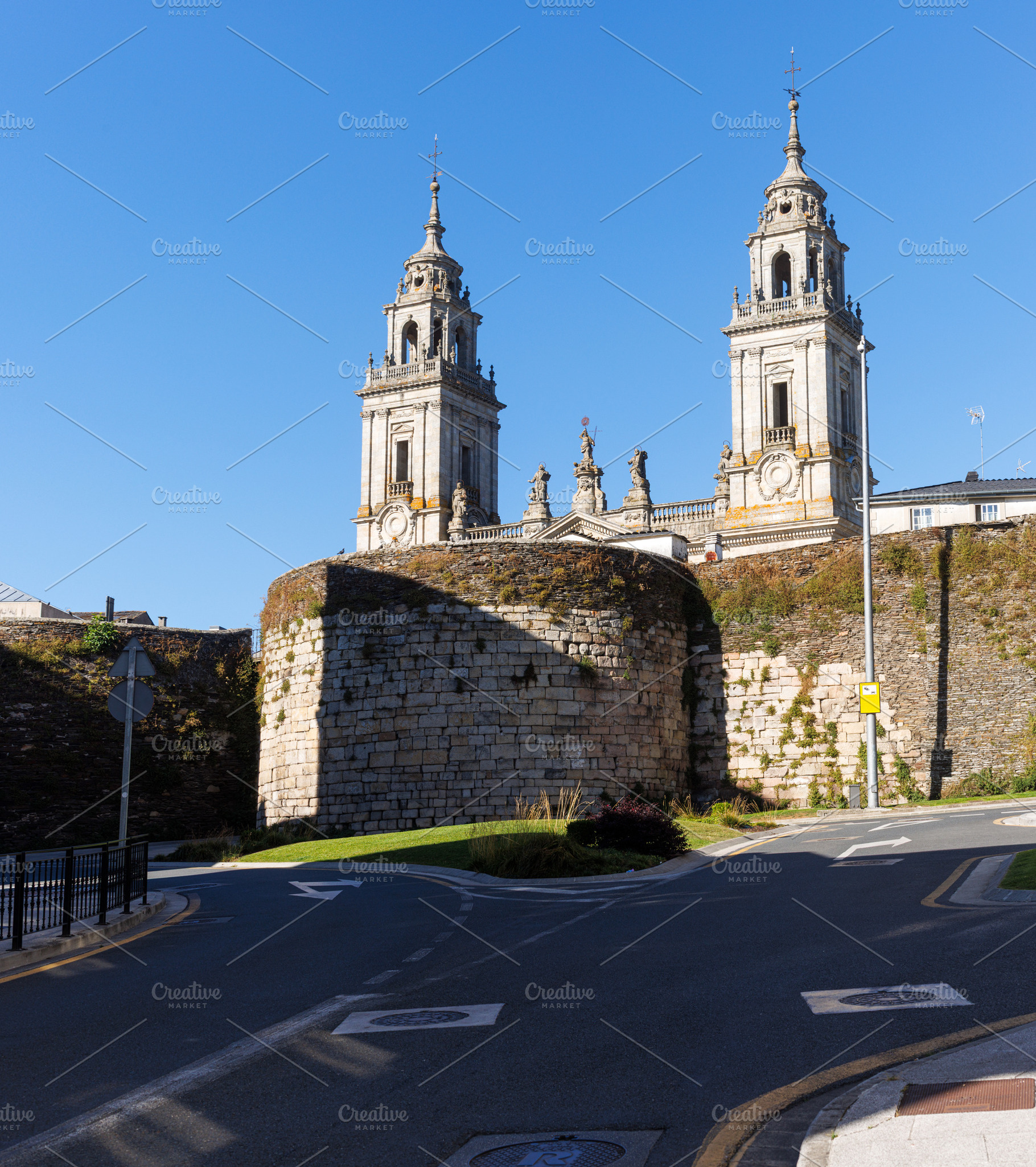 Lugo Cathedral rising behind the ancient Roman walls and defensive tower, an Architecture Photo by Bepslabor