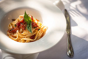 Fresh fettuccine pasta with tomato sauce and basil on a white pl, a Photo by Studio ANNA