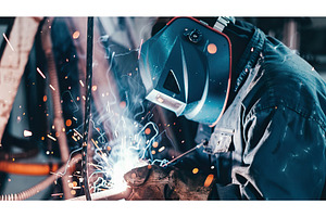 Welder welding with sparks, Wearing, an Industrial Photo by Lermont51