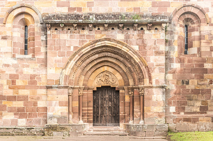 Facade of ancient stone Romanesque church entrance, a Holiday Photo by Iván Moreno STOCK PHOTO