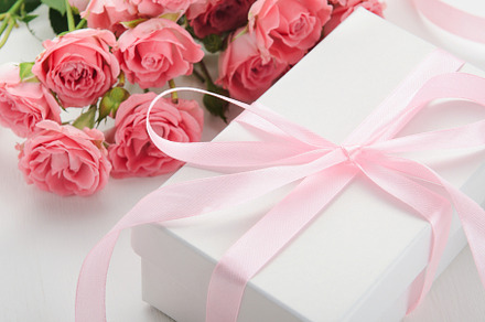 White gift box with a pink ribbon