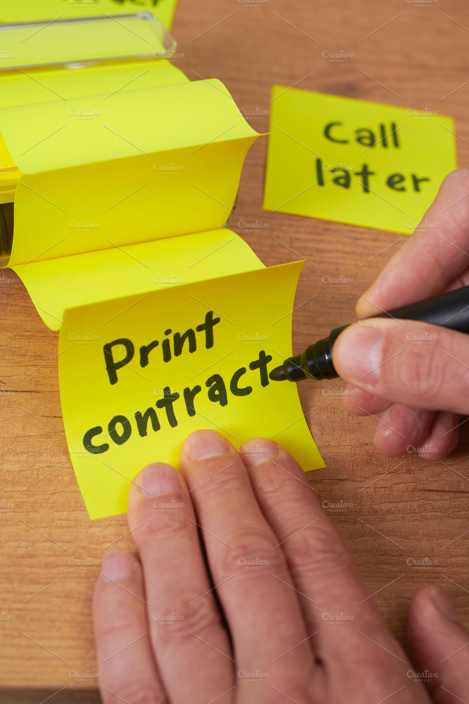 a man writing print contract on a sticky note, a Photo by Nito