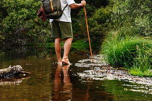 Adventurer crossing barefoot stream, a Sports & Recreation Photo by Perpis