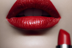 Woman's mouth with vibrant red lipstick, cosmetic product beside, a Beauty & Fashion Photo by Studio ANNA