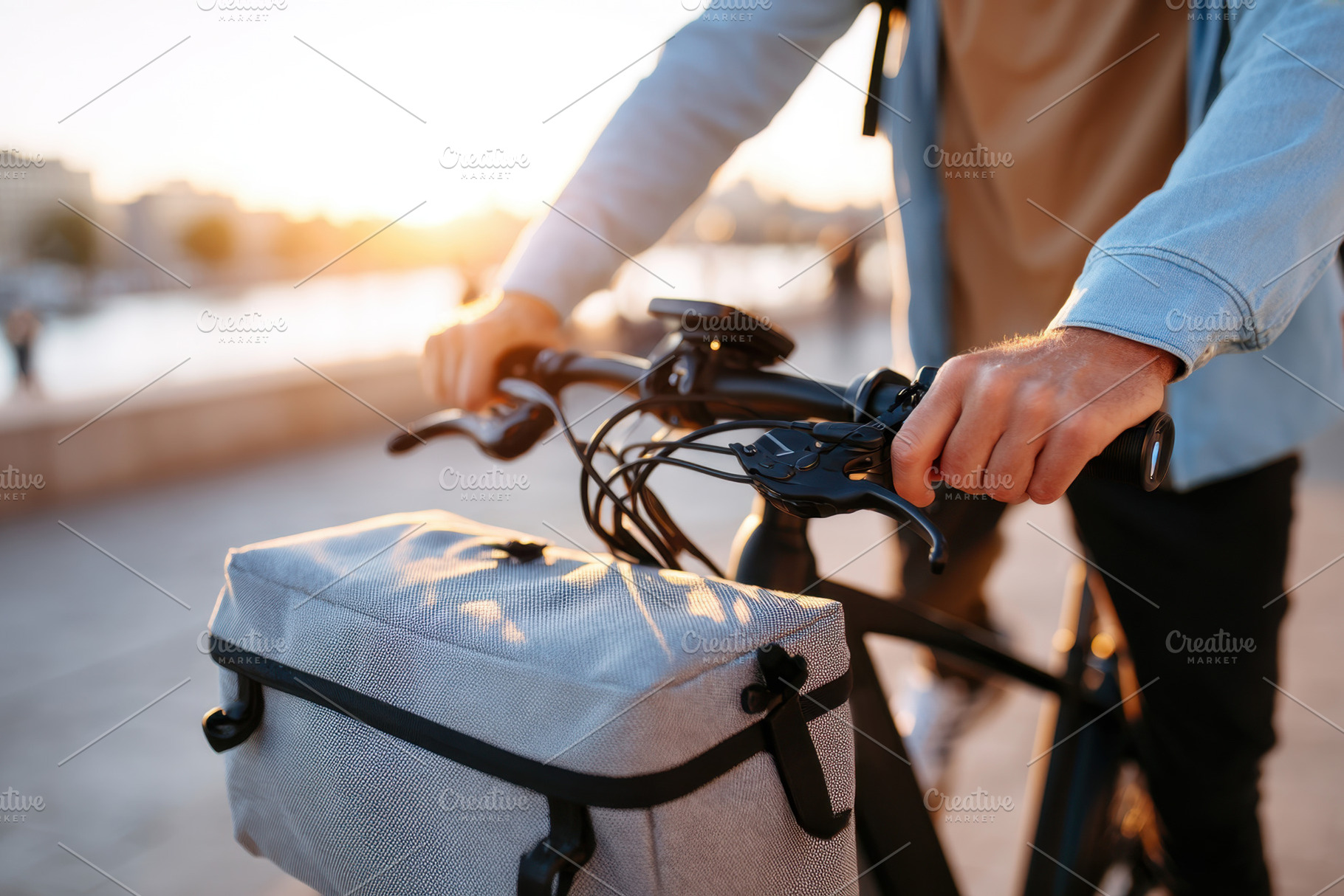 Close-up of cyclist at sunset by the waterfront, a Transportation Photo by AlyaAnd