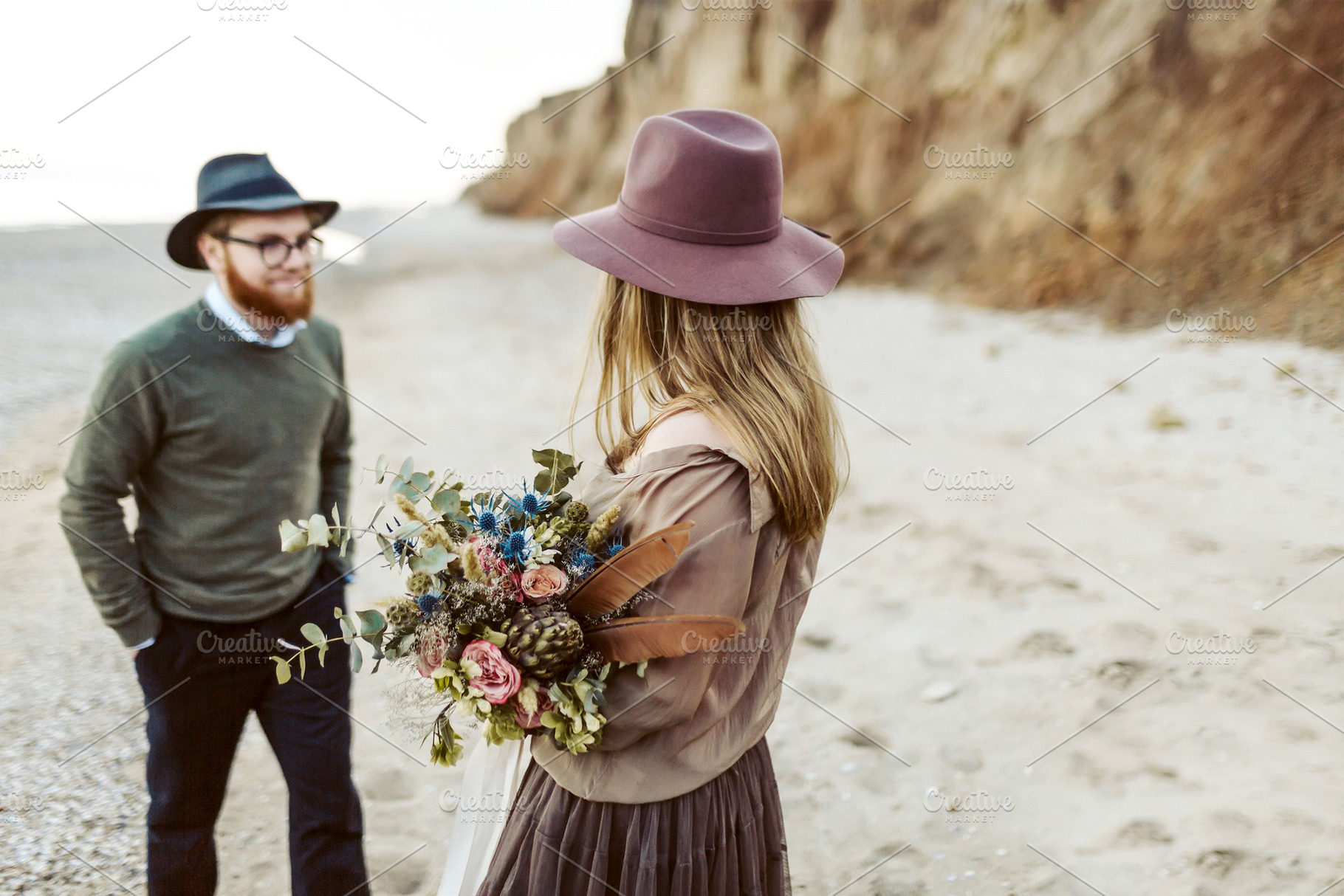 Country style wedding. Newlyweds with rustic bouquet in hands stand on seashore. Outdoors. Artwork, a Person Photo by Stahov
