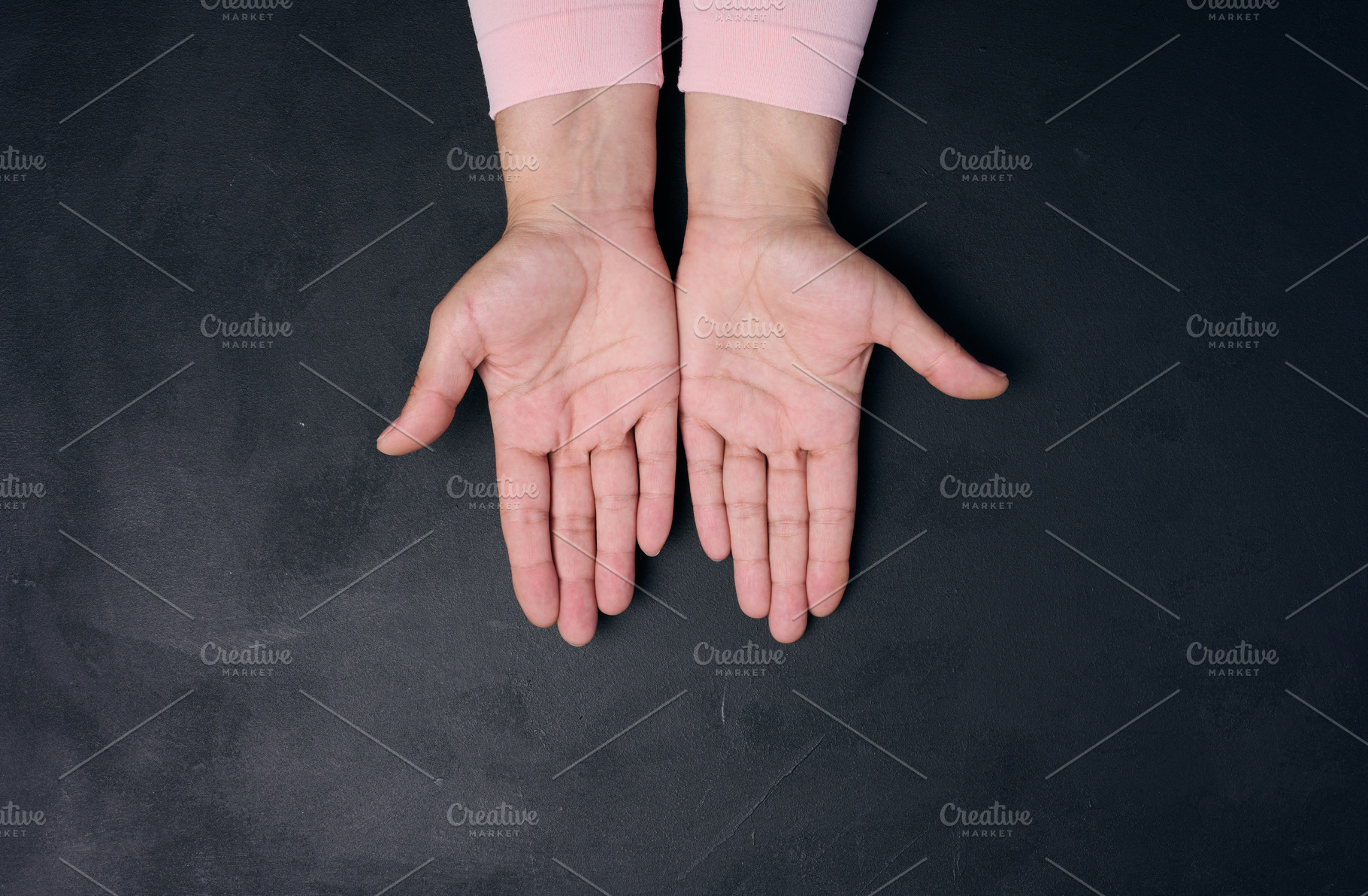 Two empty female palms, open hands on a black background, a Person Photo by ndanko