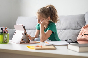 Girl studying with tablet at home, a Person Photo by etorres69