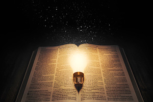 Light bulb lighting up an open bible
