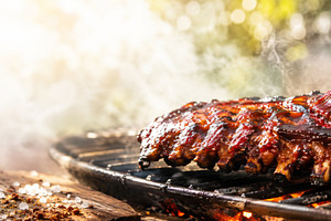 Summer BBQ ribs sizzling on grill wi, a Photo by Dvoevnore photos