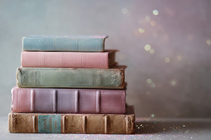 Old books stacked in soft colors, a Photo by Beautiful things