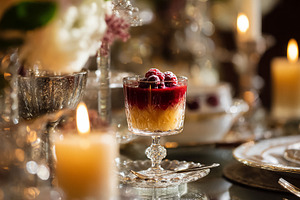 Elegant dessert parfait with raspberries on a formal dining tabl, a Photo by Studio ANNA