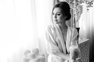 A young bride sits at a slot machine in the morning and drinks c