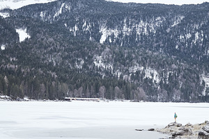 Tourist at winter mountain lake featuring active, activity, and adventure
