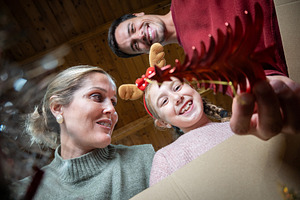 Smiling girl looking into box of Christmas decorations, a Holiday Photo by etorres69