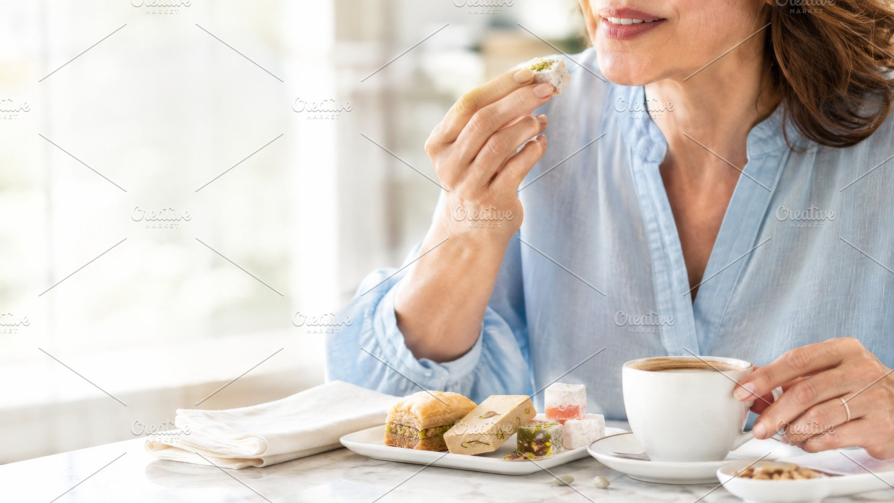 Woman enjoying Turkish sweets with c, a Photo by Dvoevnore photos