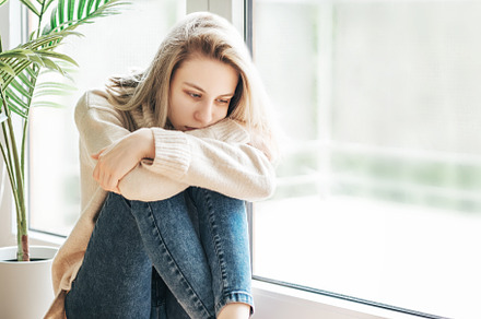 Sad girl near window thinking about something, a Person Photo by Olena Rudo