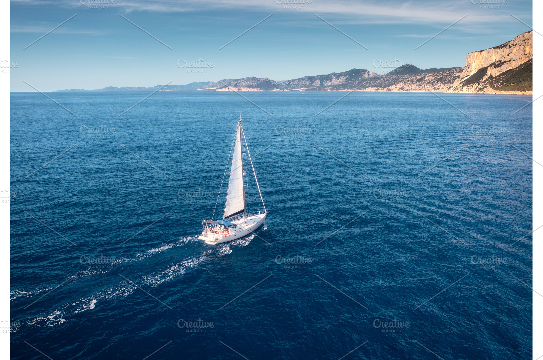 Aerial view of floating sailboat and, a Transportation Photo by den-belitsky