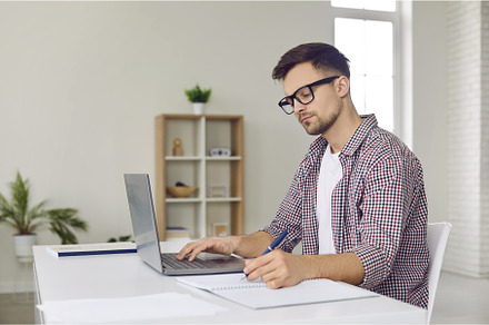 Remote student in glasses sitting at, a School & Education Photo by StudioRomantic