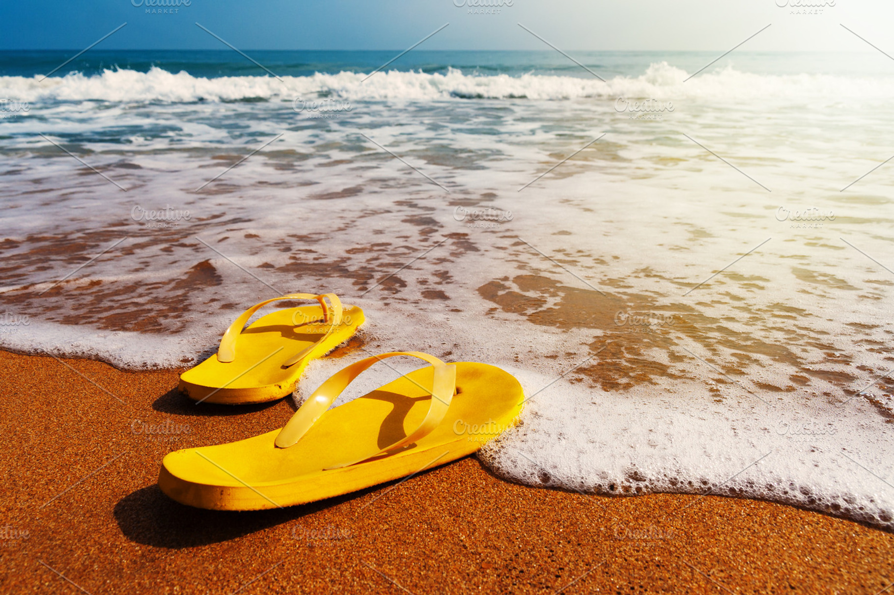 Beach slippers on sandy beach, a Holiday Photo by chamillewhite