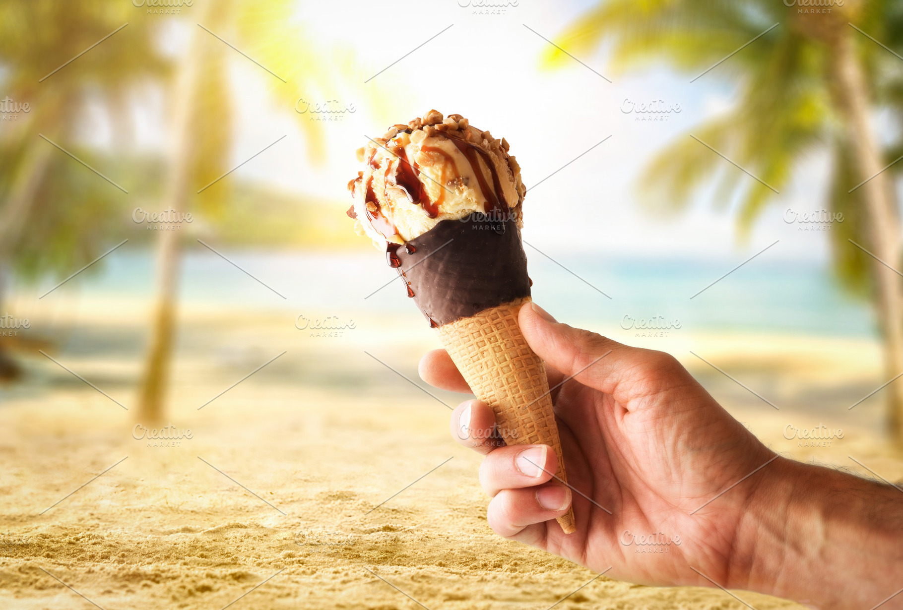 Hand holding ice cream cone on vacation with beach background, a Food ...
