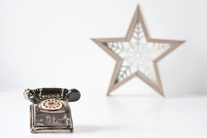 Toy old telephone made of ceramics