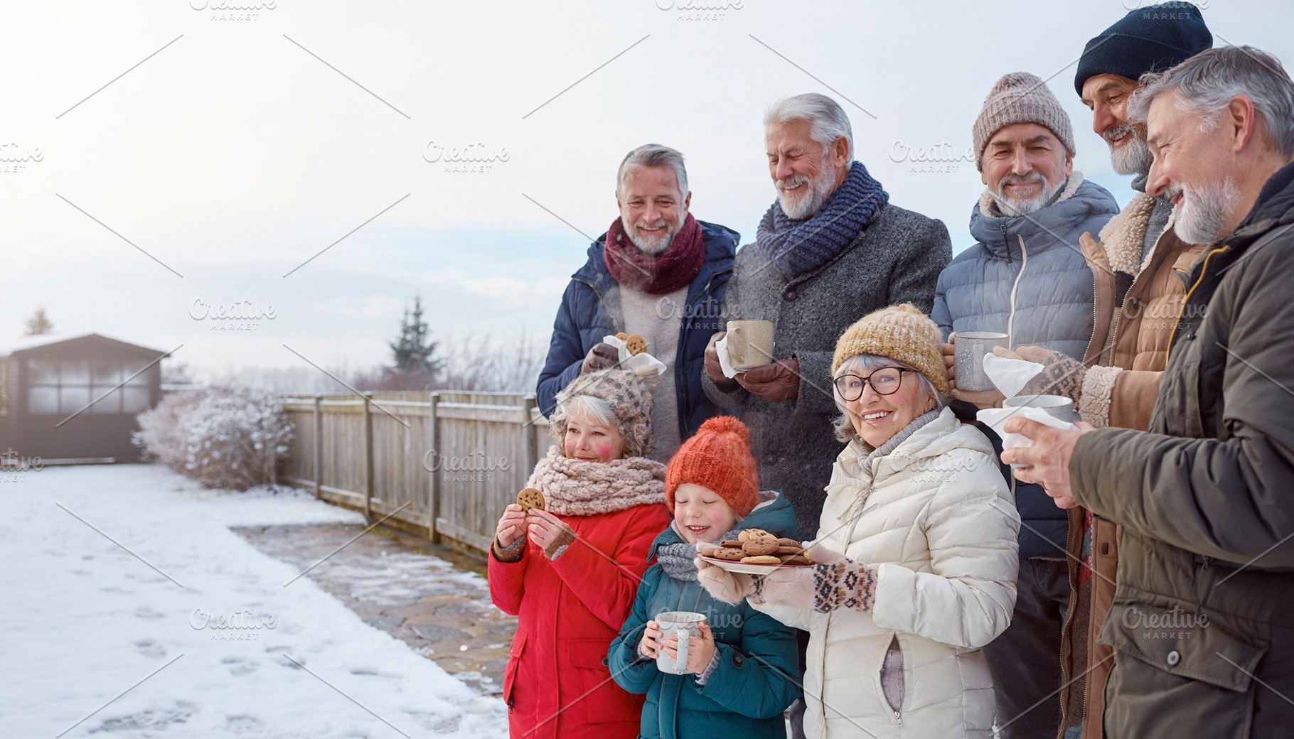 Family gathering in snowy yard with hot drinks, a Person Photo by DanFLCreativo