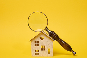 Magnifying glass with a wooden handle lying on a decorative toy, a Business Photo by ndanko