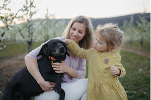 Girl with mother and dog in the, a Person Photo by HalfPoint
