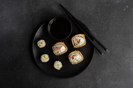 Fried sushi and avocako maki on the plate, a Food & Drink Photo by Anna Bogush