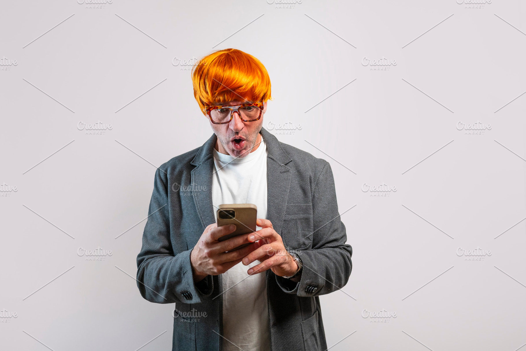 Adult man looking at smartphone with shocked expression, a Person Photo by karrastock