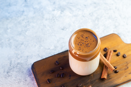 Dalgona coffee. Iced fluffy creamy whipped trend drink with coffee foam and mil, a Food & Drink Photo by PavelKant