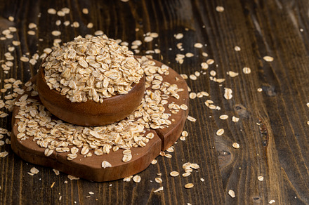 Oat flakes poured into a wooden bowl, a Food & Drink Photo by MyPhotos