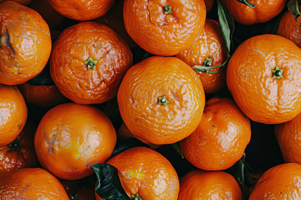 A variety of ripe oranges are stacke, a Photo by Tanuart