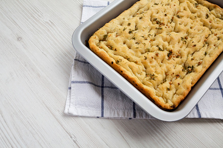 Home-baked Rosemary Garlic Focaccia Bread, side view. Copy space, a Food & Drink Photo by LiudmylaChuhunova