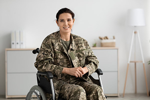 Rehabilitation Programs For Veterans. Portrait Of Happy Military Woman Sitting, a Photo by Prostock-Studio