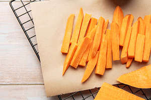 Preparing raw sweet potato fries for healthy cooking, a Food & Drink Photo by Olena Rudo