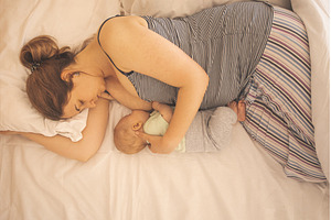 Mother and newborn baby sleep in the