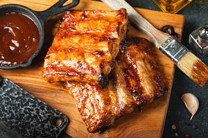 Spicy hot grilled spare ribs from a summer BBQ served with a hot chili pepper a, a Food & Drink Photo by Budarinphoto