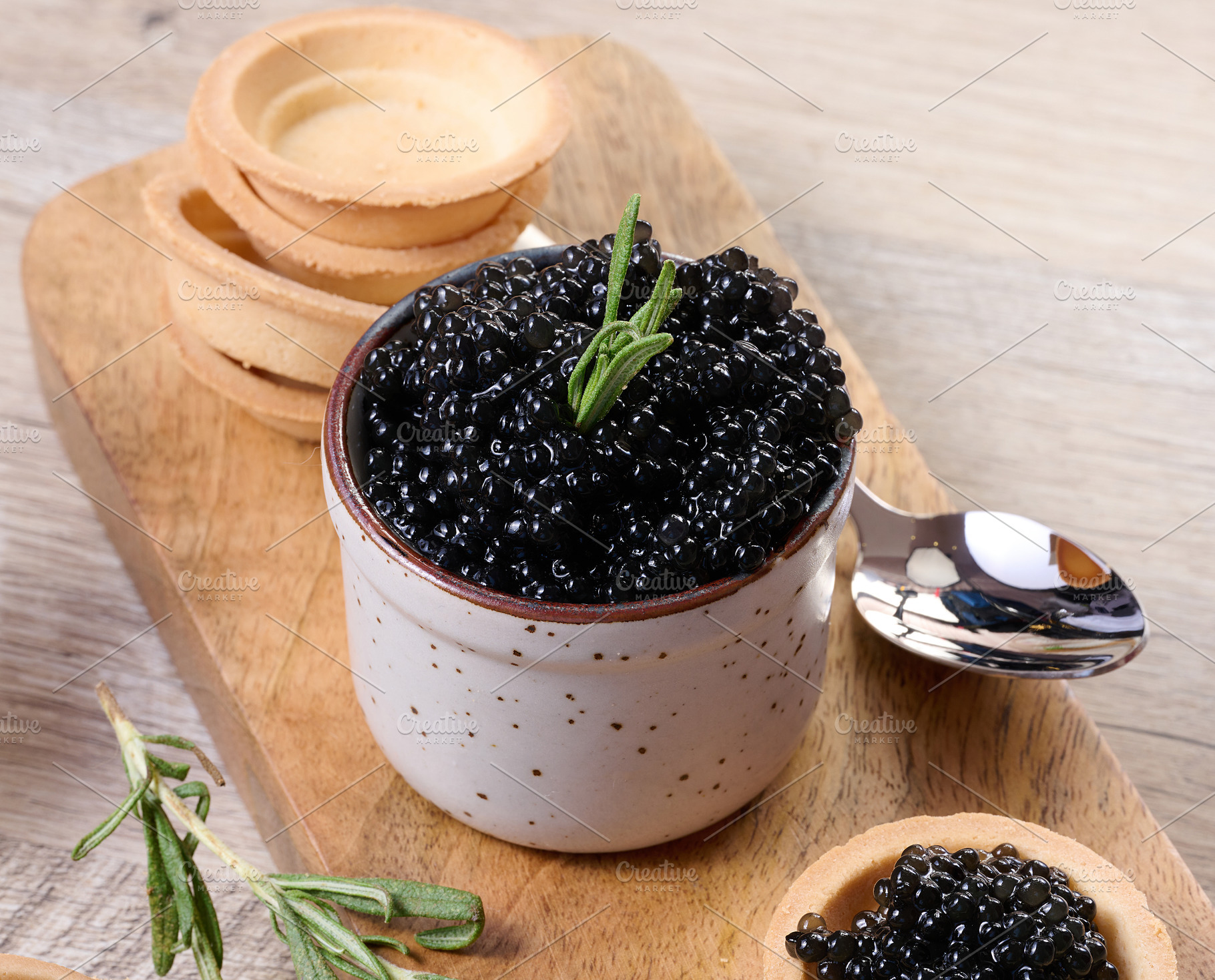 Close-up of black caviar in ceramic pot and mini tartlet placed, a Food & Drink Photo by ndanko